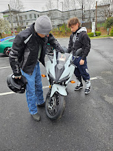 Geoff and his son picking up his son's motorcycle.