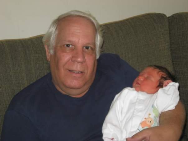 Dad holding his granddaughter Jaden