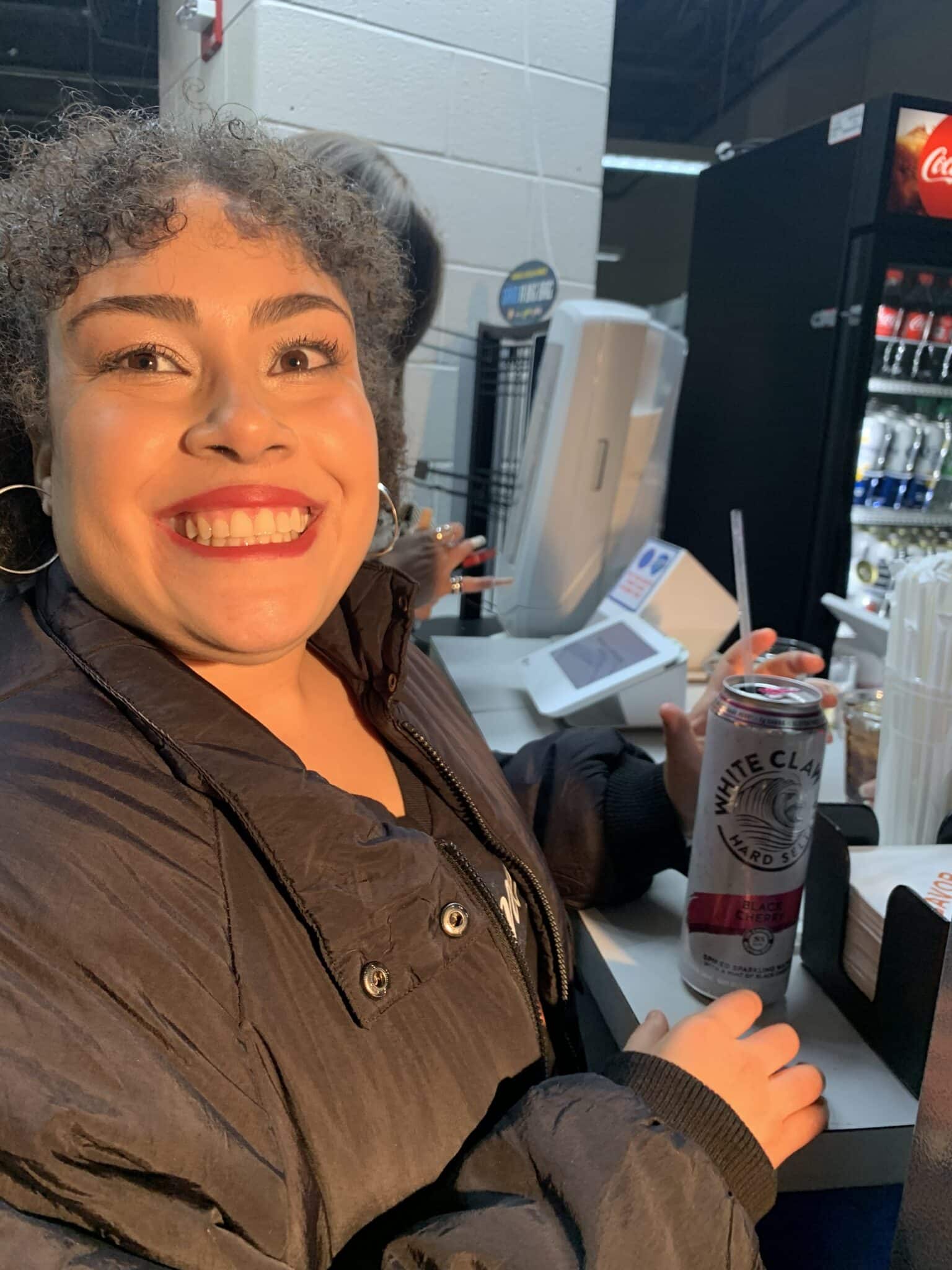 Excited cause she was going to see Romeo Santos and finally was able to buy for the first time a drink
